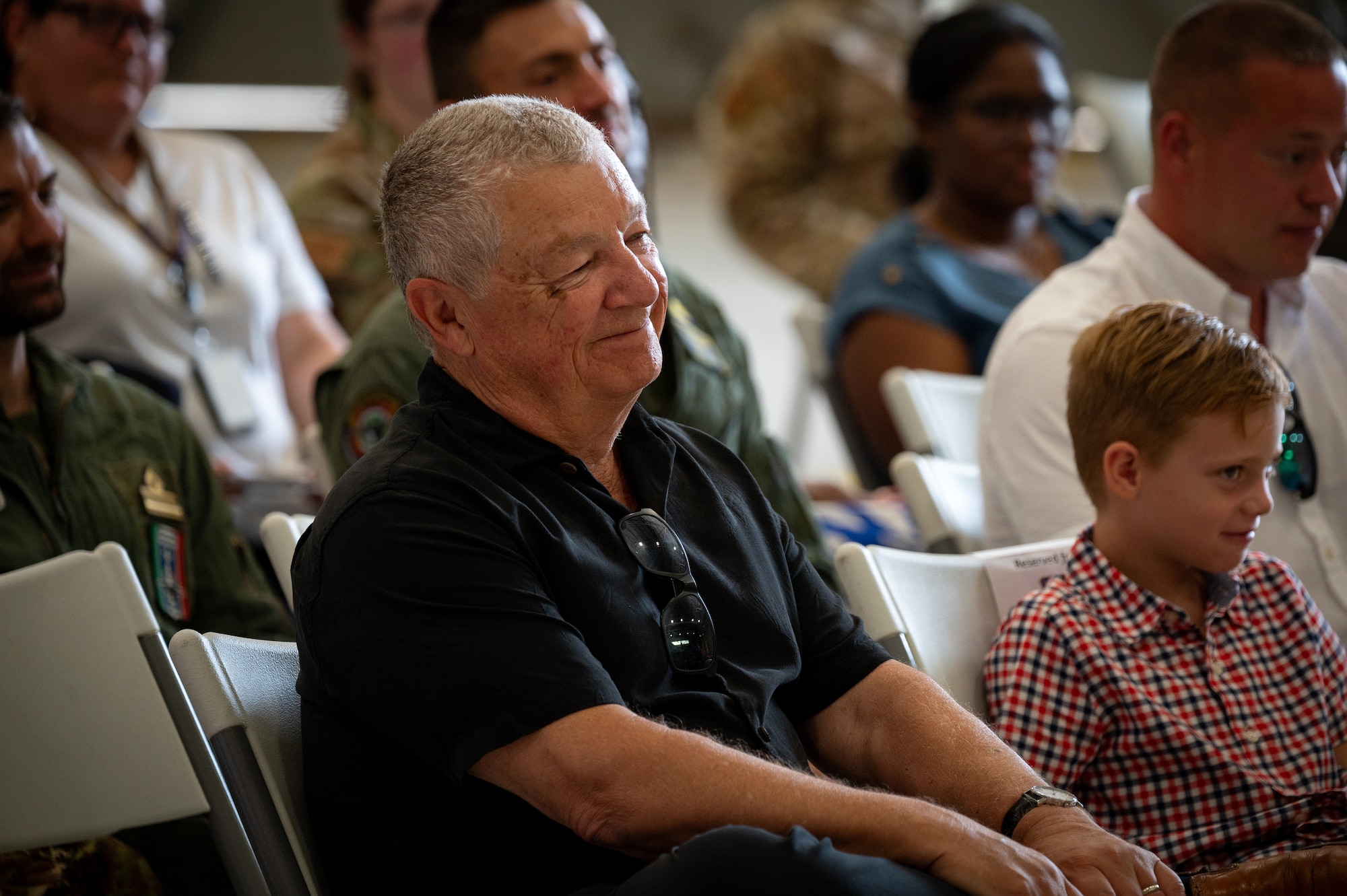 A family member of U.S. Navy Cmdr. Alexander Sandroni, 513th Electronic Warfare Squadron commander, sit during the 513th EWS change of command ceremony at Eglin Air Force Base, Florida, June 18, 2024. The mission of the 513th EWS is to provide combat-credible mission data to the F-35 warfighter, requiring in-depth expertise on the F-35 aircraft, intelligence analysis, mission data programming, and software development. (Courtesy Photo)