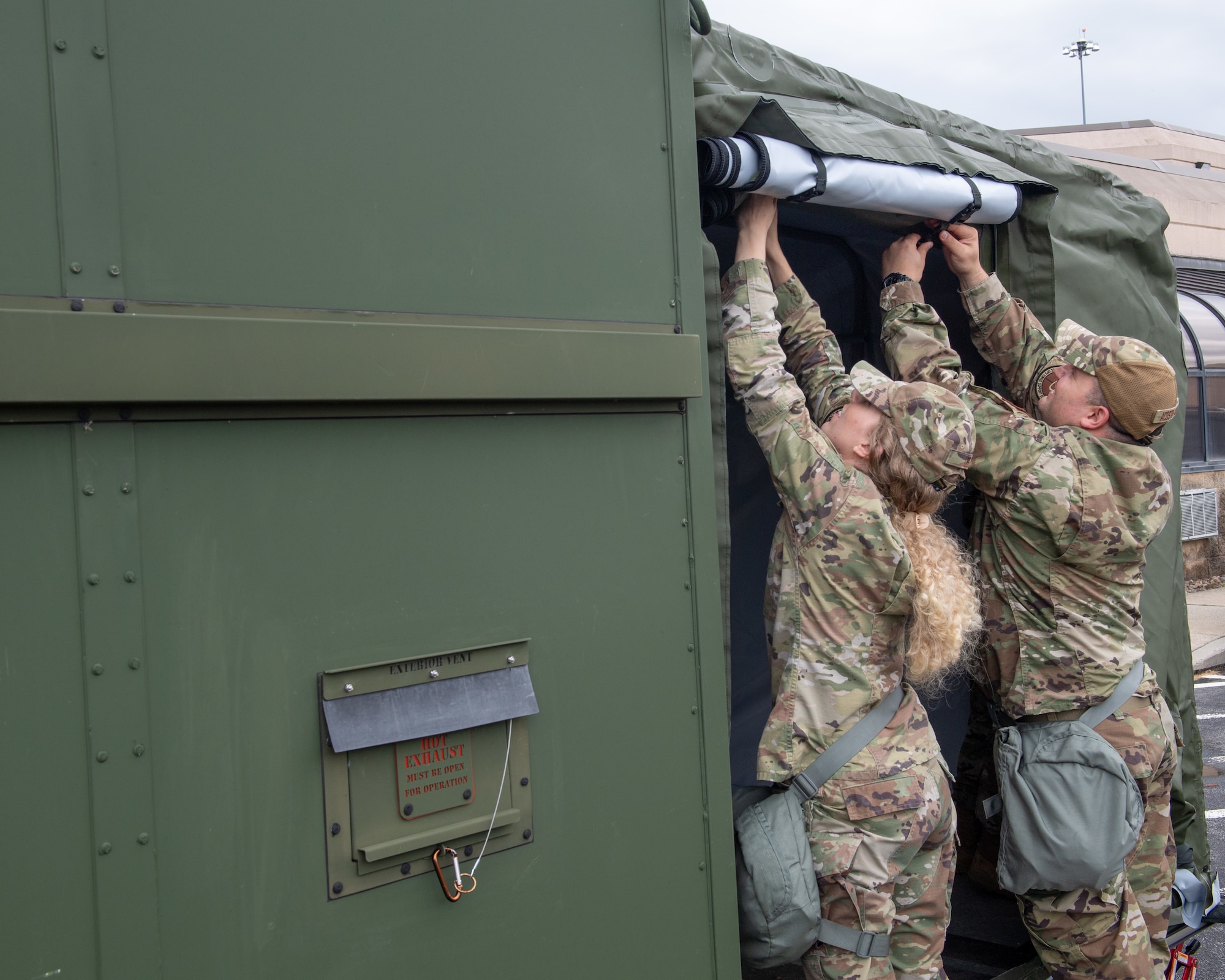 193 Special Operations Wing Airmen roll up the side tarp of the Expandable Single Pallet Expeditionary Kitchen in Middletown, Pennsylvania, on June 6, 2024.