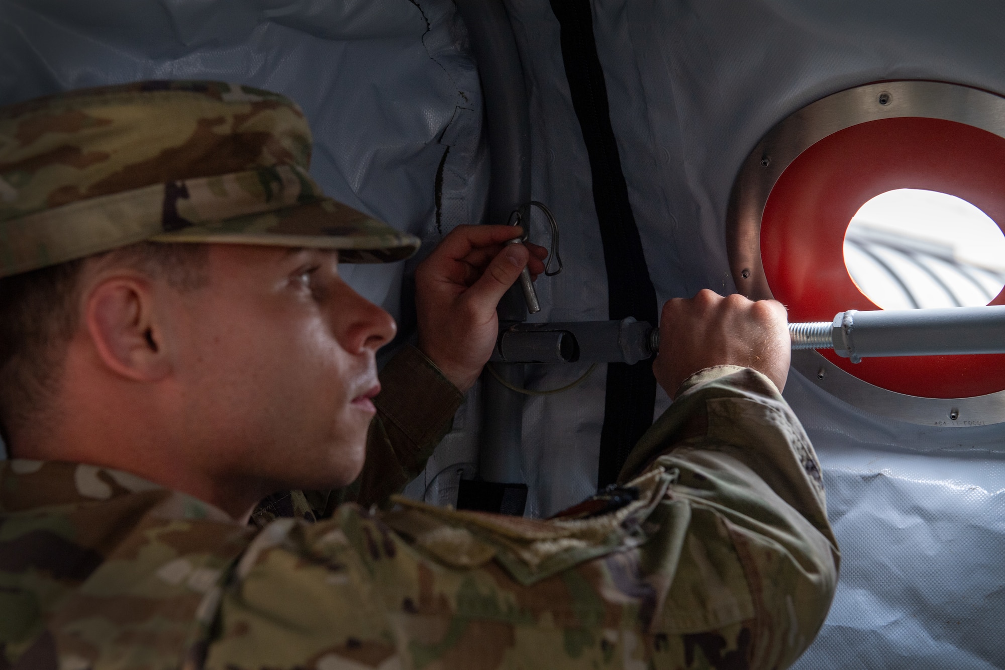 A 193rd Special Operations Wing Airman sets up the interior support system of the Expandable Single Pallet Expeditionary Kitchen on base in Middletown, Pennsylvania, on June 6, 2024.