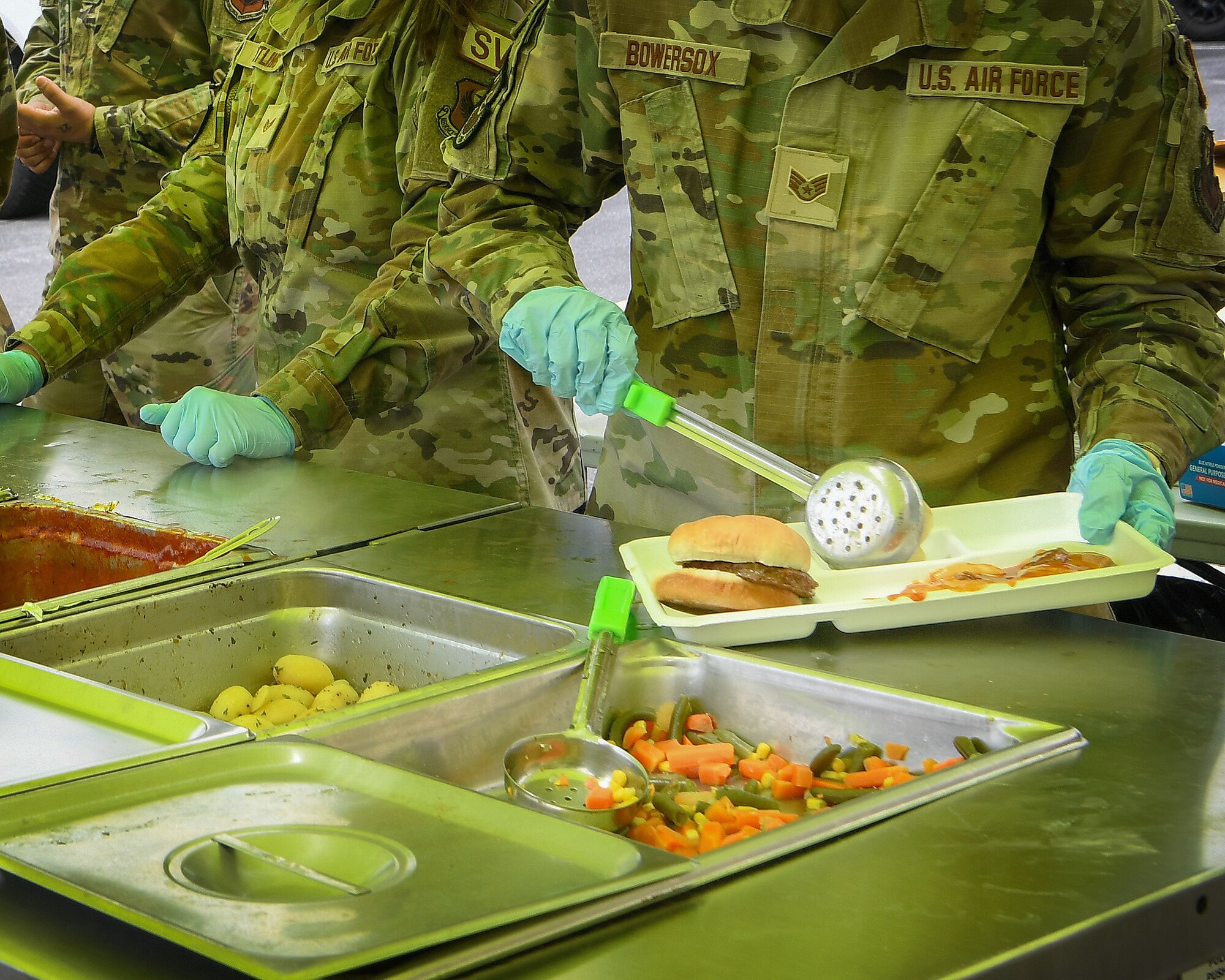 193rd Special Operations Wing Airmen serve food from the Expandable Single Pallet Expeditionary Kitchen in Middletown, Pennsylvania, during Exercise Iron Keystone 24 on June 7, 2024.