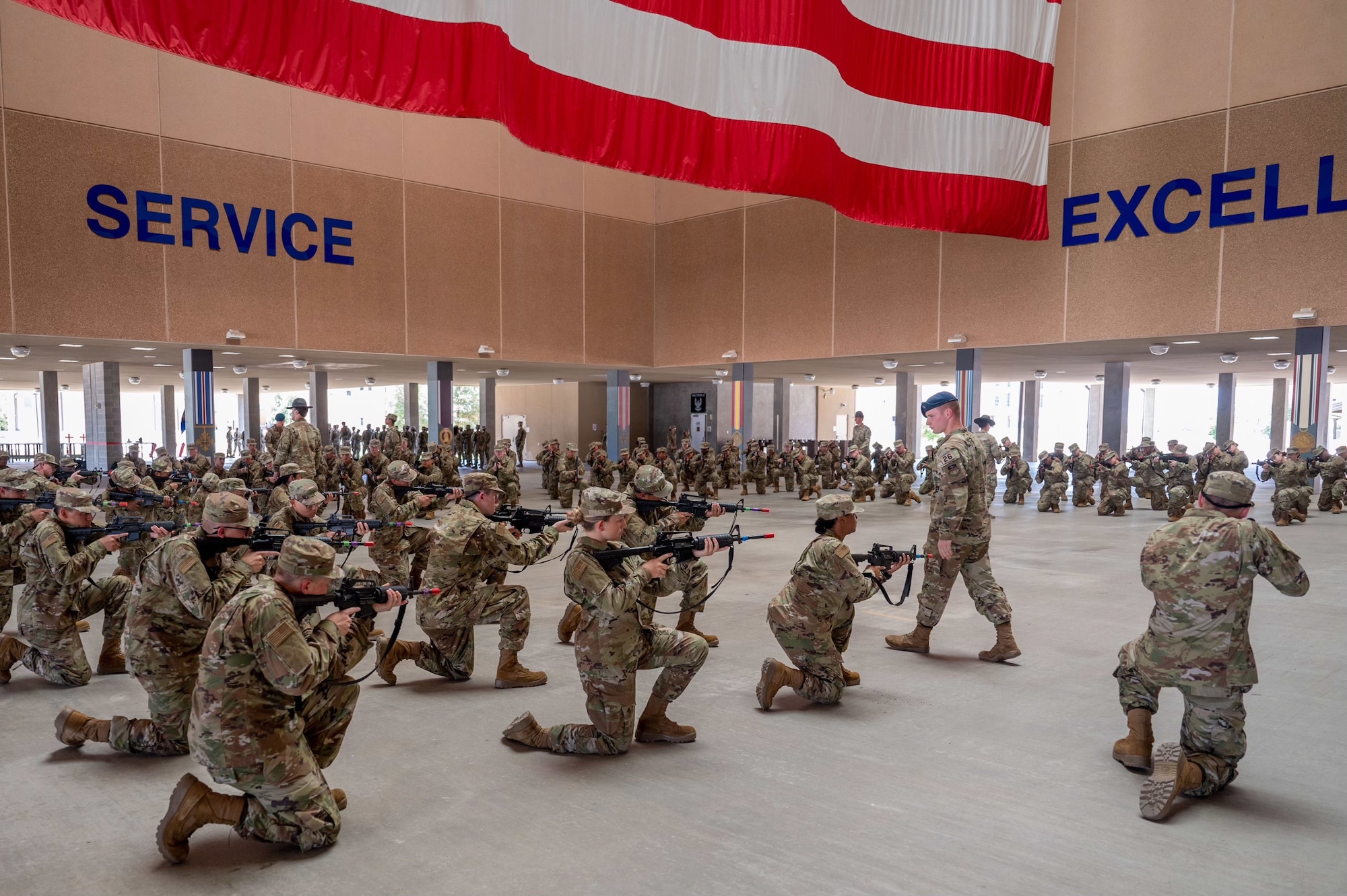 Cadet 2nd Class Seth Hanenburg (standing) with the U.S. Air Force Academy observes and gives feedback to Basic Military Training trainees with the 321st Training Squadron during a weapons handling lesson on June 17, 2024, at Joint Base San Antonio-Lackland, Texas. The Summer Leadership Program at USAFA provides cadets with the opportunity to collaborate with BMT MTIs at the 737th Training Group for three weeks in June. When the cadets return to USAFA in the fall, they will lead the six-week indoctrination program, Basic Cadet Training, for incoming USAFA students. The 321 TRS, is just one of 10 training squadrons, that guide and coach the next generation of Airmen at BMT. (U.S. Air Force photo by Ava Leone)