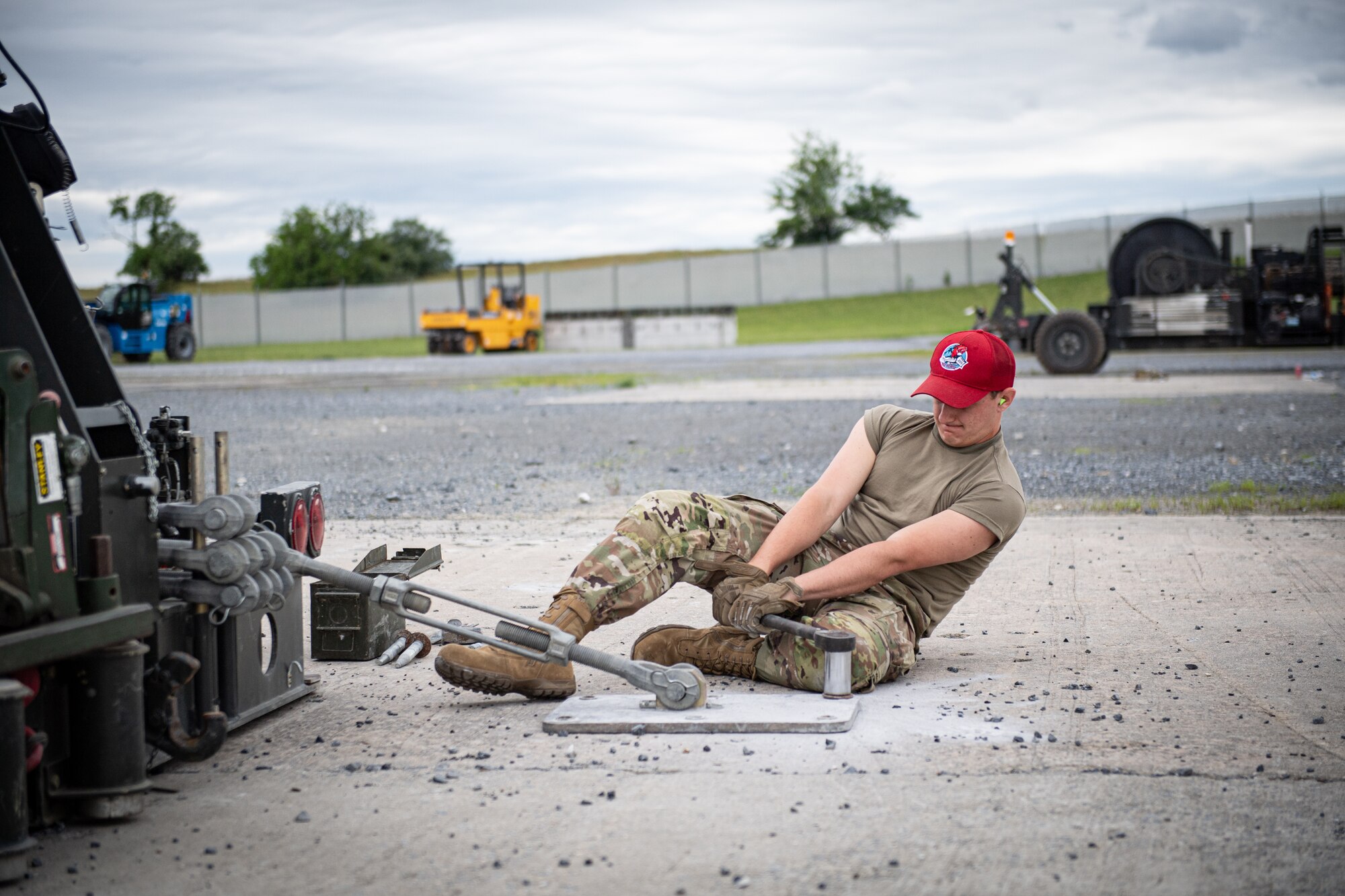 Airmen from the 201st RED HORSE Squadron set up a mobile aircraft arresting system during Pennsylvania Air National Guard exercise Iron Keystone 24 at Fort Indiantown Gap, Pennsylvania, June 9, 2024.
