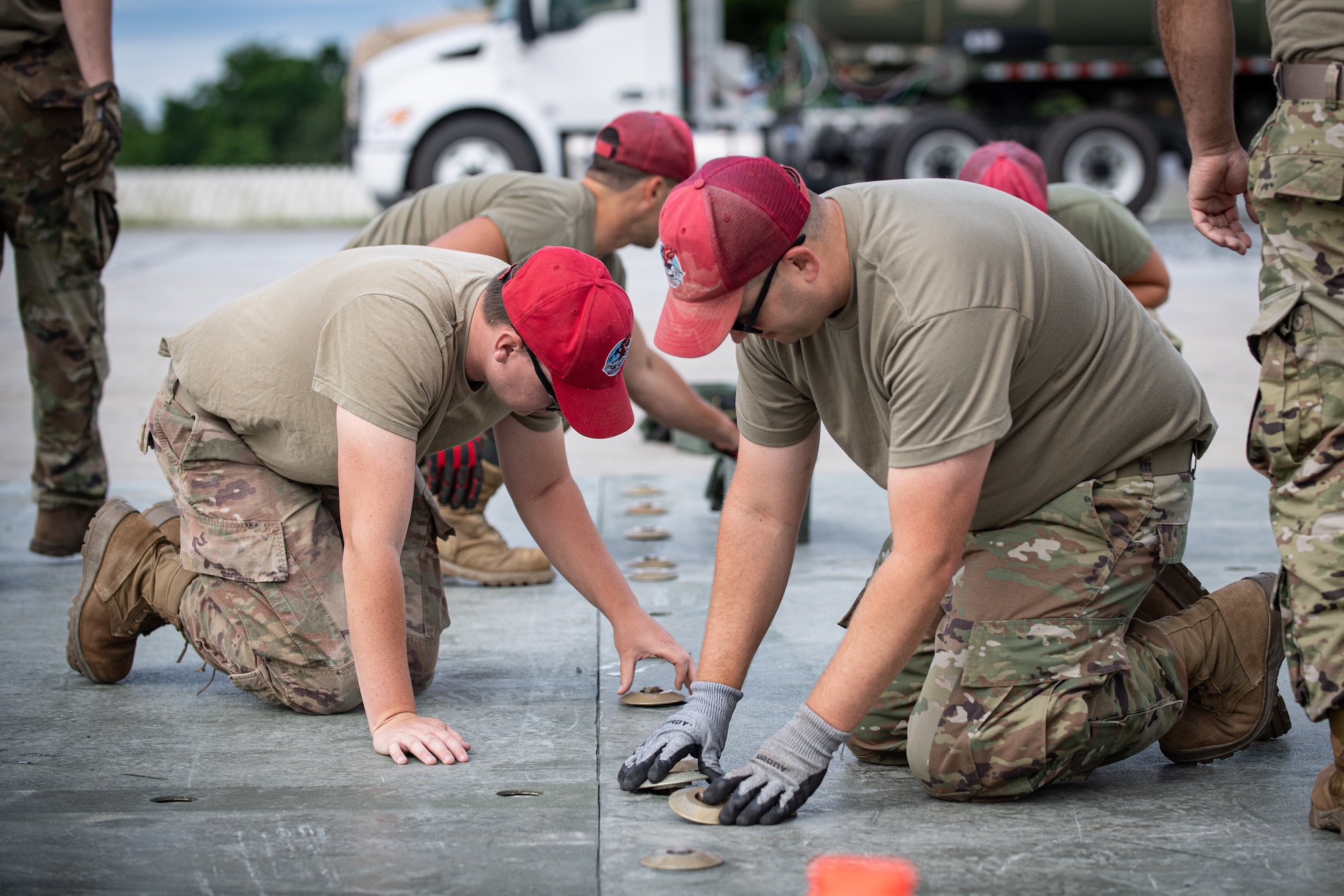 Airmen from the 201st RED HORSE Squadron connect fiber reinforced polymer panels to simulate repairing an aircraft runway during Pennsylvania Air National Guard exercise Iron Keystone 24 at Fort Indiantown Gap, Pennsylvania, June 9, 2024.