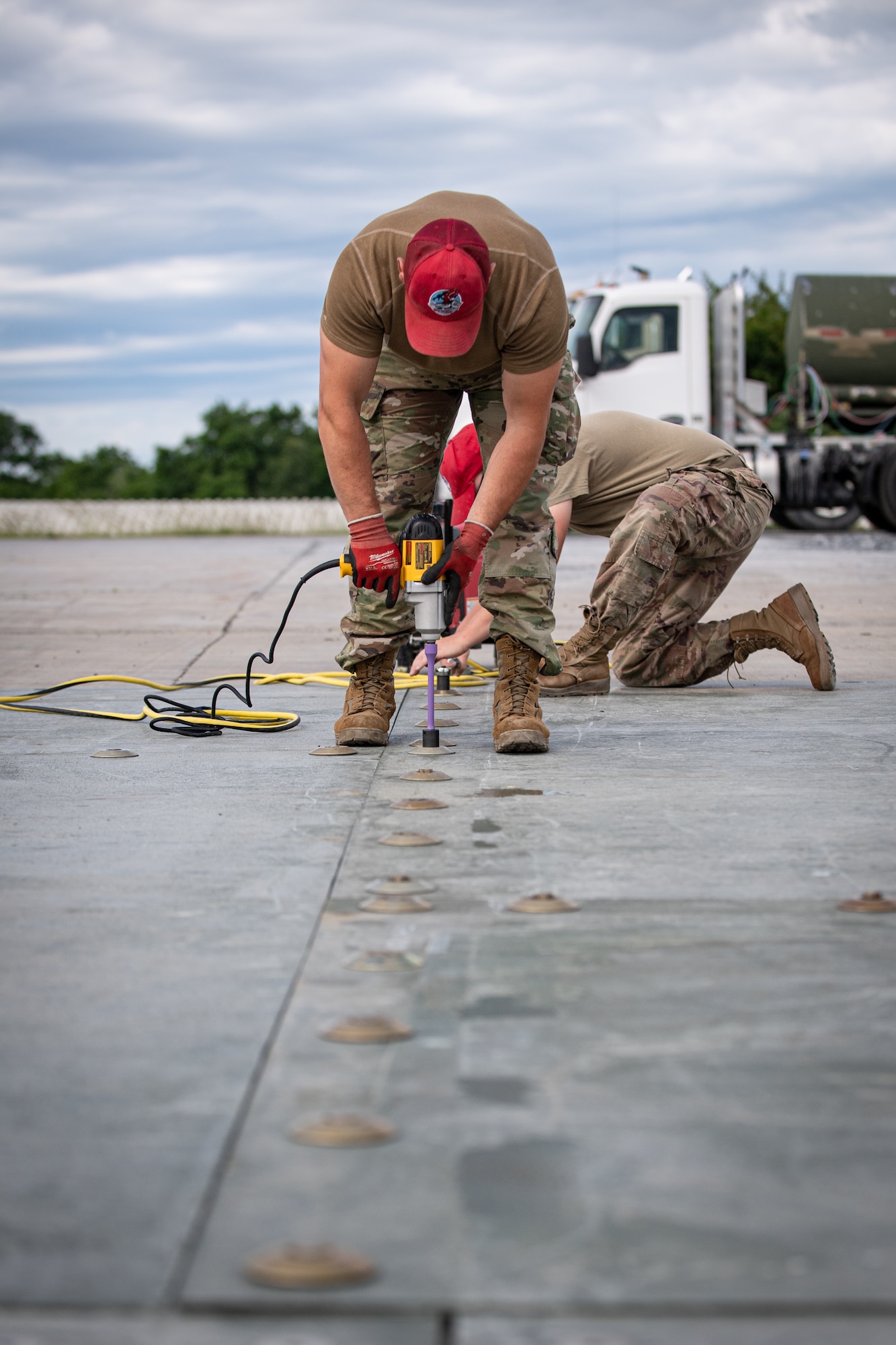 Airmen from the 201st RED HORSE Squadron connect fiber reinforced polymer panels to simulate repairing an aircraft runway during Pennsylvania Air National Guard exercise Iron Keystone 24 at Fort Indiantown Gap, Pennsylvania, June 9, 2024.