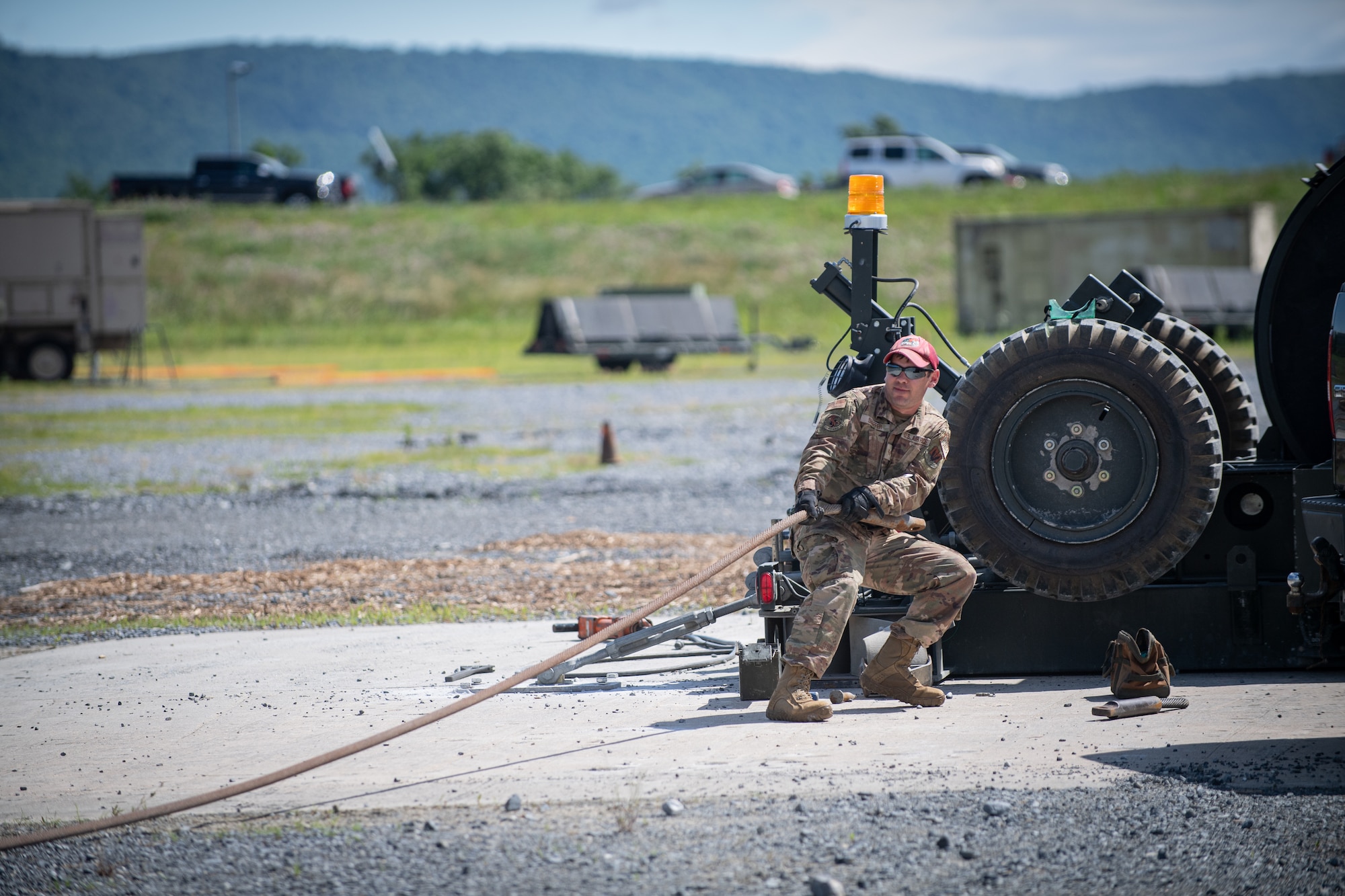 Airmen from the 201st RED HORSE Squadron set up a mobile aircraft arresting system during Pennsylvania Air National Guard exercise Iron Keystone 24 at Fort Indiantown Gap, Pennsylvania, June 9, 2024.