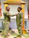 Senior Enlisted Advisor Tony Whitehead, SEA to the chief, National Guard Bureau, promotes his niece to the rank of sergeant first class at Camp Bondsteel, Kosovo, June 24, 2024. Sgt. 1st Class Jasmine Promise, paralegal NCO in charge of the Regional Command East legal office, is deployed to Kosovo with the Georgia National Guard’s 48th Infantry Brigade, supporting the Kosovo Force.