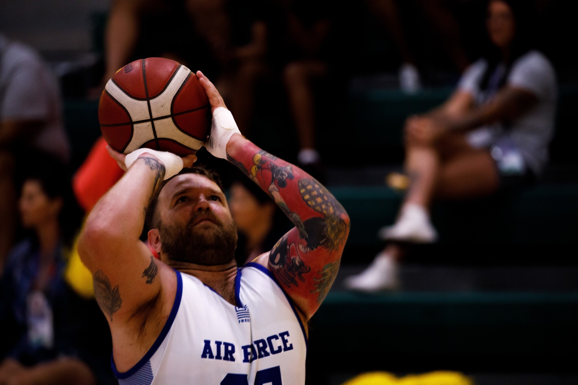 U.S. Air Force Staff Sgt. Curtis Belew, an athlete with Team Air Force, shoots the basketball during the wheelchair basketball preliminaries for the 2024 Department of Defense Warrior Games