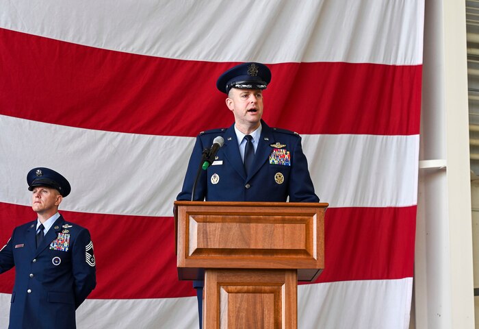 The wing commander speaks at a lecturn