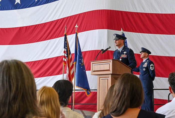 A group commander speaks at a lecturn
