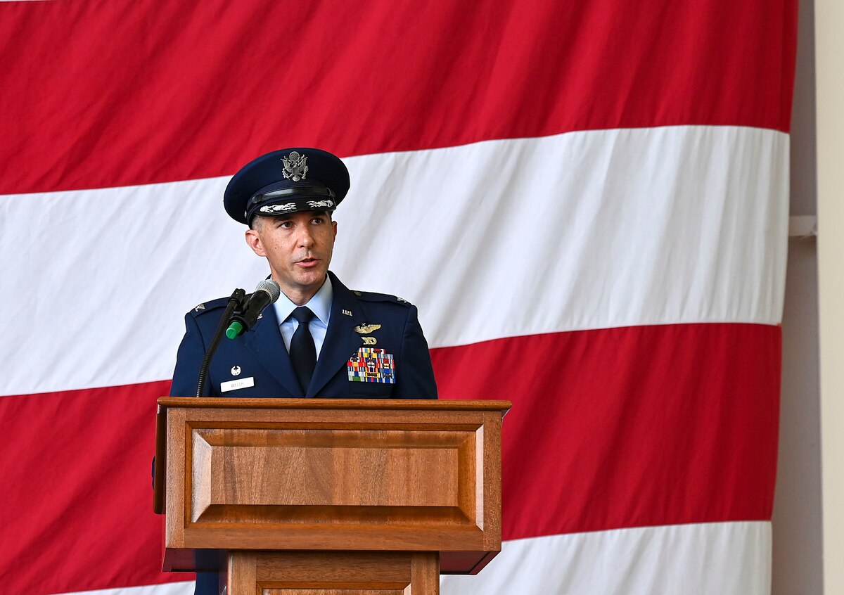 A commander speaks at a lecturn