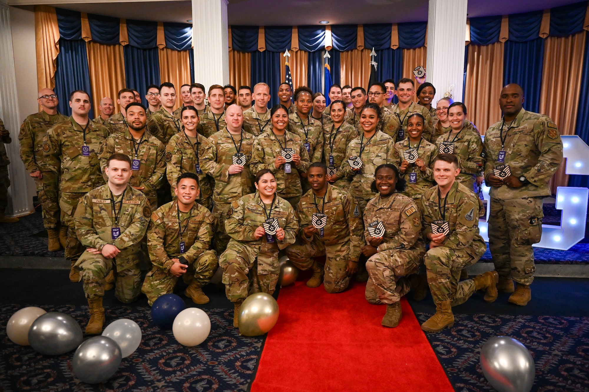 U.S. Air Force newly promoted technical sergeants pose for a photo after the technical sergeant release party hosted at the Bolling Club on Joint Base Anacostia-Bolling, Washington, D.C., June 24, 2024. Forty-eight staff sergeants were promoted to technical sergeants with their friends, families and colleagues in attendance. (U.S. Air Force photo by Airman Shanel Toussaint)