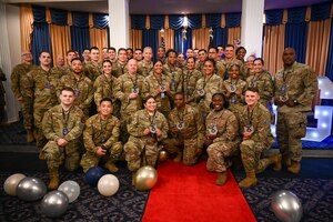 U.S. Air Force newly promoted technical sergeants pose for a photo after the technical sergeant release party hosted at the Bolling Club on Joint Base Anacostia-Bolling, Washington, D.C., June 24, 2024. Forty-eight staff sergeants were promoted to technical sergeants with their friends, families and colleagues in attendance. (U.S. Air Force photo by Airman Shanel Toussaint)