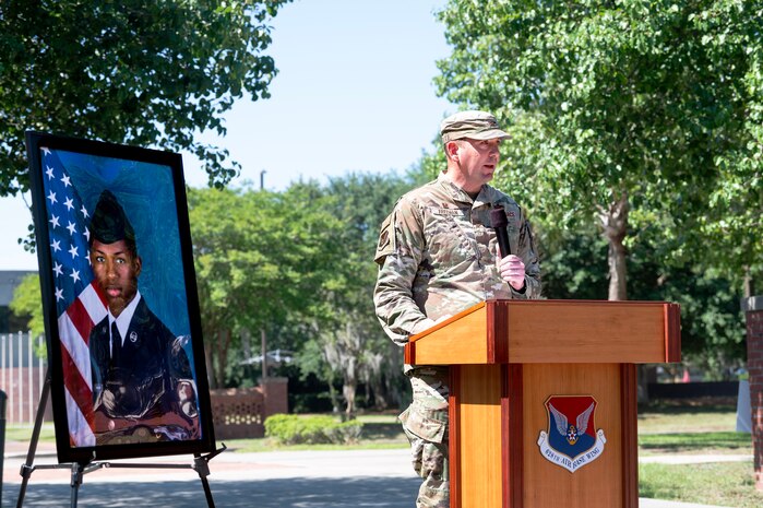 A photo of a man speaking to a crowd.