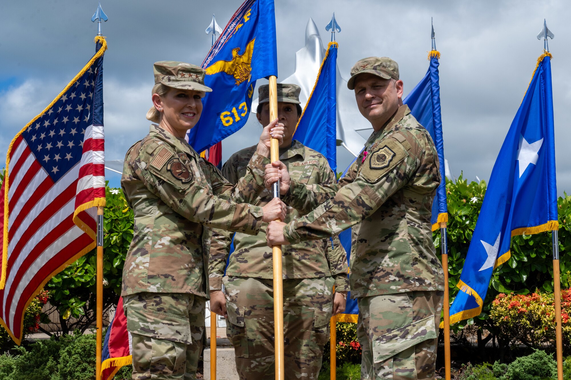 Airmen hold a flag.
