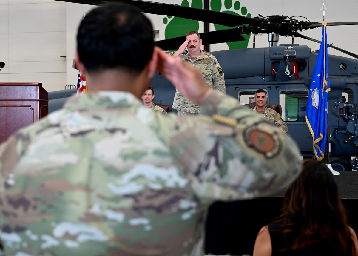 A U.S. Airman assigned to the 563rd Rescue Group provides Col. Charles Redmond, 563rd Rescue Group incoming commander, his first salute during the 563rd RQG Change of Command at Davis-Monthan Air Force Base, Ariz., June 28, 2024. The first salute represents the Group welcoming its new commander. (U.S. Air Force photo by Staff Sgt. Abbey Rieves)