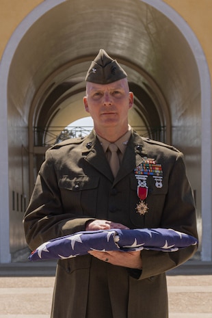 U.S. Marine Corps Col. William Brown, the assistant chief of staff of recruiting Marine Corps Recruit Depot San Diego and the Western Recruiting Region, holds a flag during his retirement ceremony at MCRD San Diego, California, June 21, 2024. Brown has faithfully served in the Marine Corps for more than 25 years in many positions such as; Air Delivery Platoon Commander during Operation IRAQI FREEDOM, Marine Aide-de-camp to the Chief of Naval Operations, and the Assistant chief of Staff, Recruiting, Western Recruiting Region where he was responsible for the management of the Marine Corps’ recruiting mission throughout the western-half of the United States. (U.S. Marine Corps photo by Lance Cpl. Alexandra M. Earl)
