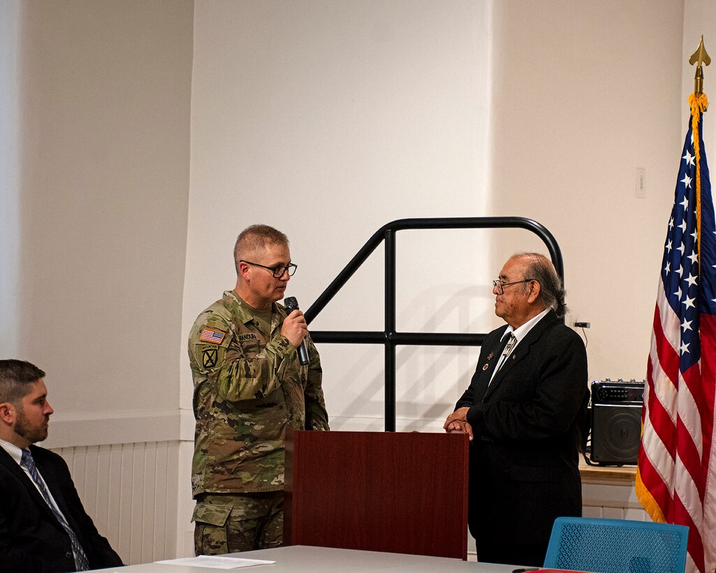 Col. James Handura, standing left, commander, USACE-South Pacific Division, addresses the audience and Pueblo of Isleta Gov. Max Zuni before the signing of a partnership agreement to begin a cultural preservation study for the historic Pottery Mound site, June 26, 2024. Entering the agreement is the first step in beginning a comprehensive study of erosion at the Pottery Mound and evaluating what solutions can be put in place to protect the site.
