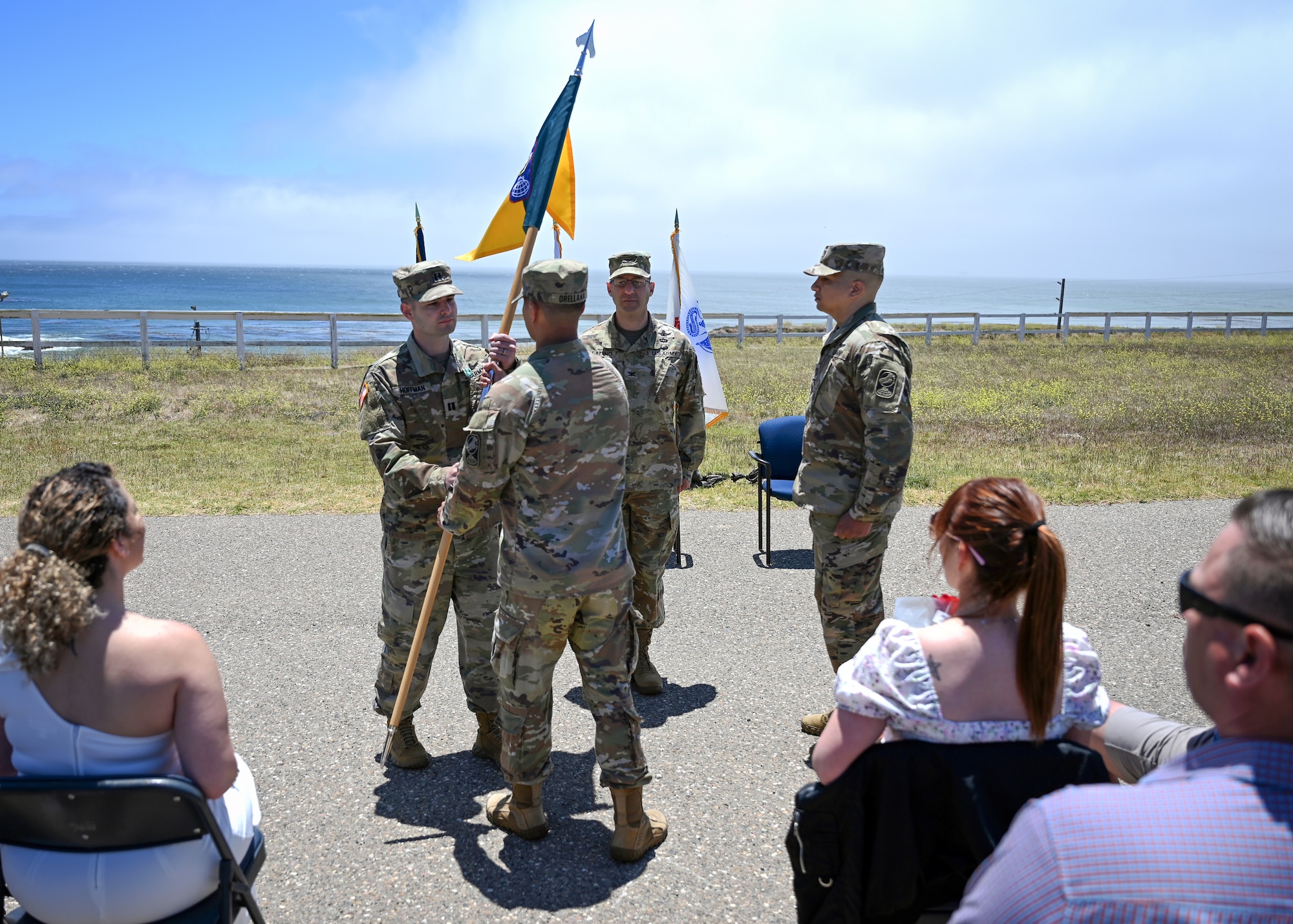 A man passes a flag to another man.