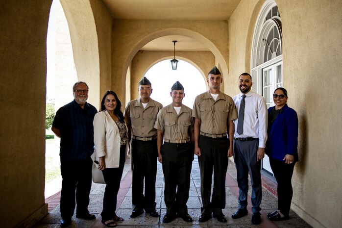U.S. Marines with Echo Company, 2nd Recruit Training Battalion, pose for a photo with their sponsors after a naturalization ceremony at Marine Corps Recruit Depot, San Diego, June 27, 2024. The naturalization ceremony took place during family day to recognize Marines who became United States citizens by completing bootcamp. (U.S. Marine Corps photo by Sgt. Yvonna Guyette)