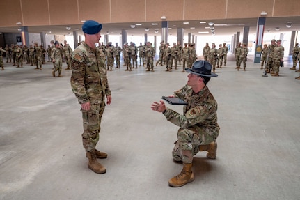 Tech. Sgt. Brian Weber, a Military Training Instructor with the 321st Training Squadron, provides guidance to U.S. Air Force Academy Cadet 2nd Class Seth Hannenburg during a weapons handling lesson for Basic Military Training trainees on June 17, 2024, at Joint Base San Antonio-Lackland, Texas. The Summer Leadership Program at USAFA provides cadets with the opportunity to collaborate with BMT MTIs at the 737th Training Group for three weeks in June. When the cadets return to USAFA in the fall, they will lead the six-week indoctrination program, Basic Cadet Training, for incoming USAFA students. The 321 TRS, is just one of 10 training squadrons, that guide and coach the next generation of Airmen at BMT. (U.S. Air Force photo by Ava Leone)