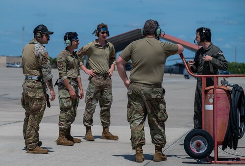Members of the 347th Rescue Group from Moody Air Force Base, Georgia, speak with each other on the flightline at Patrick Space Force Base, Florida, June 1, 2024. The team from Moody supported the Atlas V rocket Orbital Crew Flight Test mission, which launched two astronauts from Space Launch Complex 41 on Cape Canaveral Space Force Station, Florida. This was the first time since 1968 astronauts were launched from CCSFS and the first time ever from a Space Force installation. (U.S. Space Force photo by Airman 1st Class Spencer Contreras)
