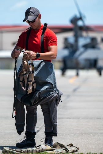 A member of the 347th Rescue Group from Moody Air Force Base, Georgia, dons his gear at Patrick Space Force Base, Florida, June 1, 2024. The team from Moody supported the Atlas V rocket Orbital Crew Flight Test mission, which launched two astronauts from Space Launch Complex 41 on Cape Canaveral Space Force Station, Florida. This was the first time since 1968 astronauts were launched from CCSFS and the first time ever from a Space Force installation. (U.S. Space Force photo by Airman 1st Class Spencer Contreras)
