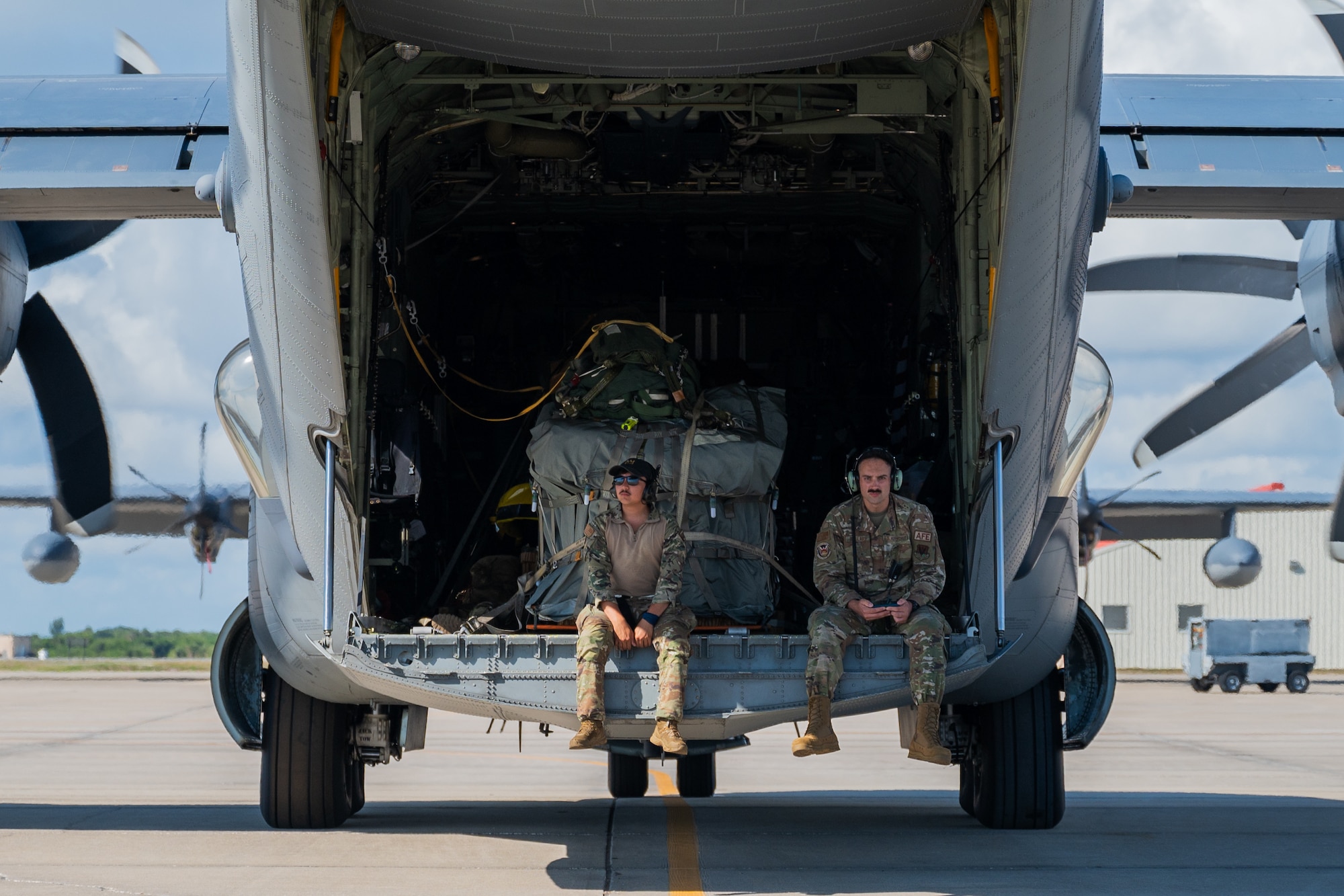 Members of the 347th Rescue Group from Moody Air Force Base, Georgia, sit in a HC-130J Combat King II loading bay at Patrick Space Force Base, Florida, June 5, 2024. The team from Moody supported the Atlas V rocket Orbital Crew Flight Test mission, which launched two astronauts from Space Launch Complex 41 on Cape Canaveral Space Force Station, Florida. This was the first time since 1968 astronauts were launched from CCSFS and the first time ever from a Space Force installation. (U.S. Space Force photo by Airman 1st Class Spencer Contreras)