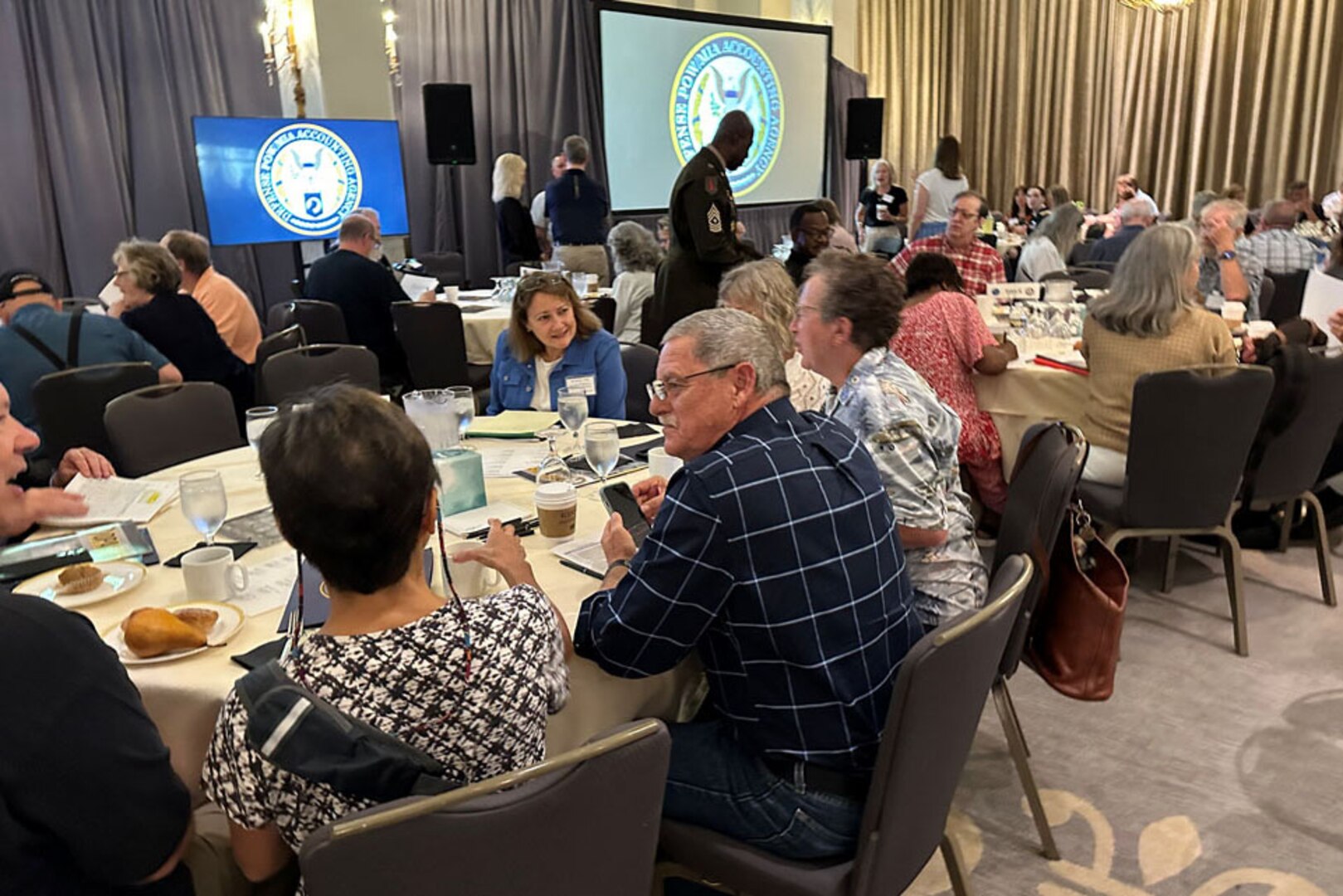 People sit at tables and chatter.