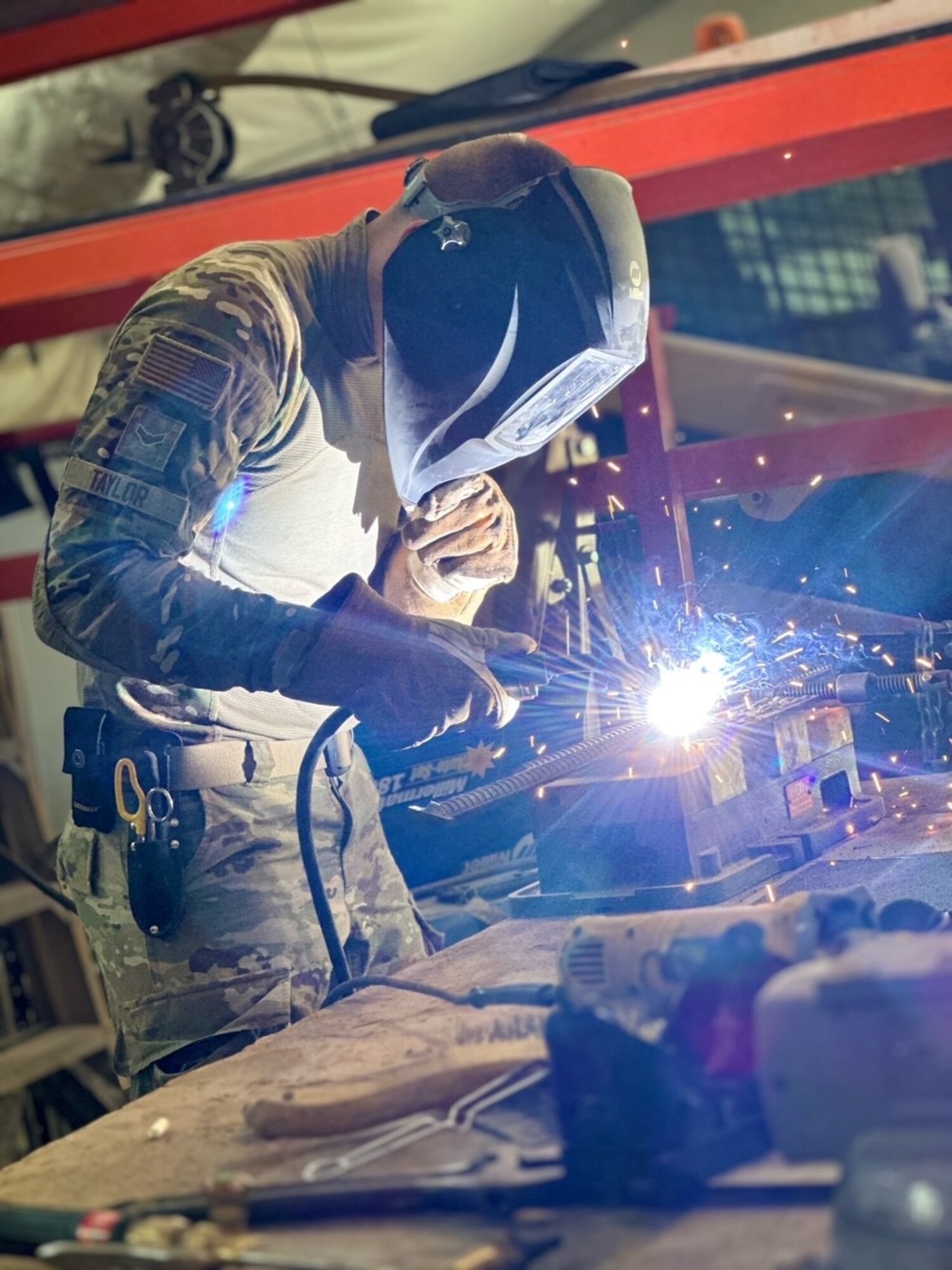 An Airman assigned to the 1st Expeditionary Theater Support Group welds at an undisclosed location within the U.S. Central Command area of responsibility, May 24, 2024. The ETSG combines episodic military labor and contract augmentation to ensure mission readiness and bolster our deterrence posture to avoid any increased regional conflict. (U.S. Air Force Courtesy photo)