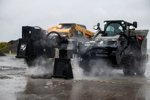 Two saw cutters are being used to cut into the cement.