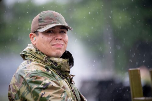A U.S. Air Force member stands in the rain.