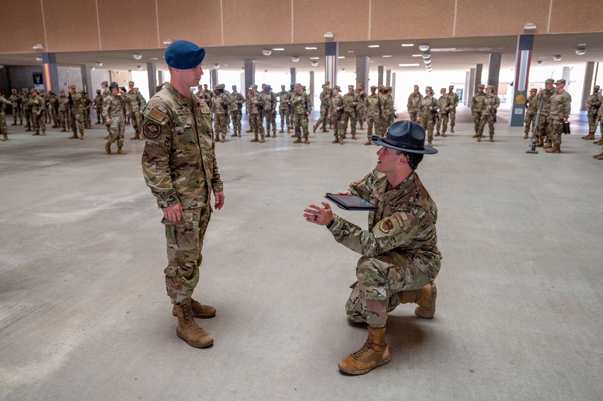 Tech. Sgt. Brian Weber, a Military Training Instructor with the 321st Training Squadron, provides guidance to U.S. Air Force Academy Cadet 2nd Class Seth Hanenburg during a weapons handling lesson for Basic Military Training trainees on June 17, 2024, at Joint Base San Antonio-Lackland, Texas. The Summer Leadership Program at USAFA provides cadets with the opportunity to collaborate with BMT MTIs at the 737th Training Group for three weeks in June. When the cadets return to USAFA in the fall, they will lead the six-week indoctrination program, Basic Cadet Training, for incoming USAFA students. The 321 TRS, is just one of 10 training squadrons, that guide and coach the next generation of Airmen at BMT. (U.S. Air Force photo by Ava Leone)
