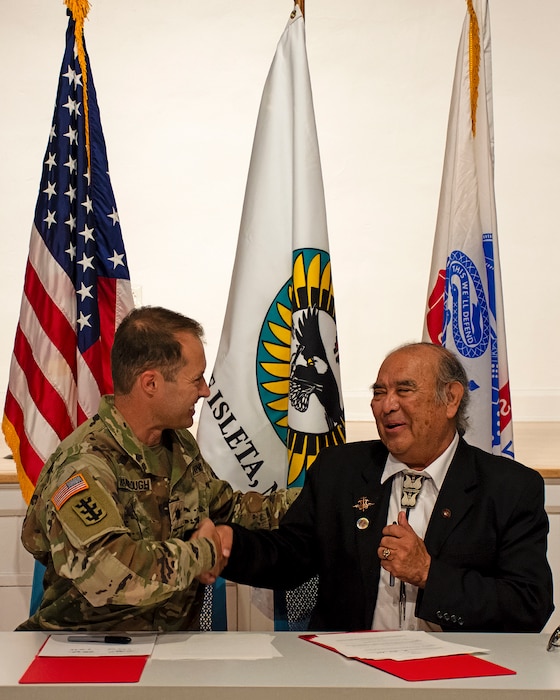 Lt. Col. Jerre Hansbrough, left, commander, USACE-Albuquerque District, and Max Zuni, governor, Pueblo of Isleta, congratulate each other after signing a partnership agreement at the Pueblo of Isleta Cultural Center, June 26, 2024, that will begin a comprehensive study of erosion at the Pottery Mound site and evaluate what solutions can be put in place to protect the site which is of historic and cultural significance to the Isleta Pueblo.