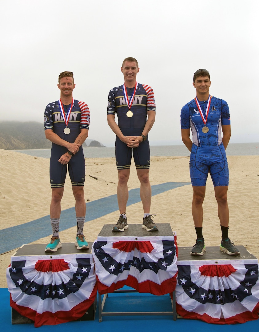 From left to right Men's Armed Forces medalists: Navy Petty Officer 2nd Class Kyle Warrick of NB San Diego, Calif.; Lt. Cmdr Kyle Hooker of the Pentagon; and Air Force 2d lt. Samuel Busa of NAS Pensacola, Florida.  2024 Armed Forces Triathlon Championships was held at Naval Base Ventura County, Calif., June 26-30. Service members from Army, Marine Corps, Navy (with Coast Guard) and Air Force (with Space Force) battled alongside the Canadian forces for gold. (U.S. Army photo by Master Sgt. Sharilyn Wells/USACAPOC(A) PAO)