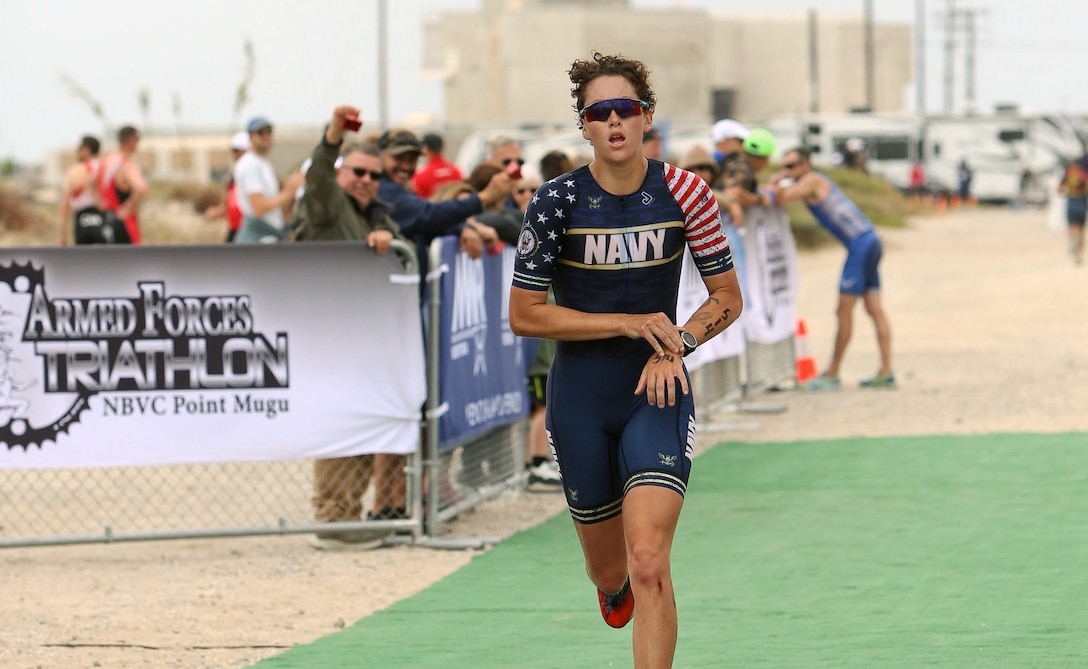 Navy Ensign Hannah Walz of NAS Pennsacola, Florida wins her first title during the 2024 Armed Forces Triathlon Championships was held at Naval Base Ventura County, Calif., June 26-30. Service members from Army, Marine Corps, Navy (with Coast Guard) and Air Force (with Space Force) battled alongside the Canadian forces for gold. (U.S. Army photo by Master Sgt. Sharilyn Wells/USACAPOC(A) PAO)