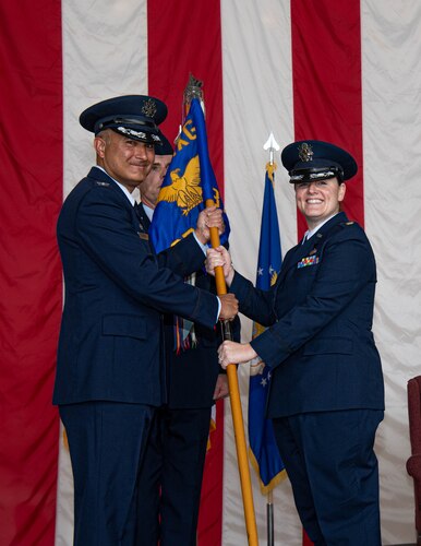 Airmen pass each other the squadron flag.