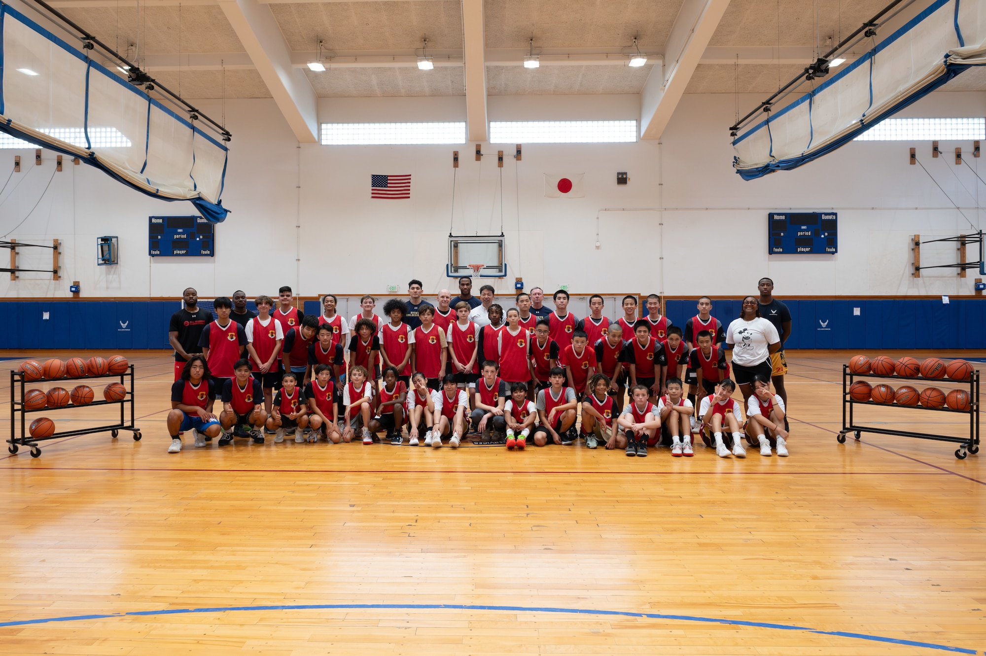 Participants, coaches and mentors of the Chatan Town and Kadena Air Base bilateral basketball camp pose for a group photo