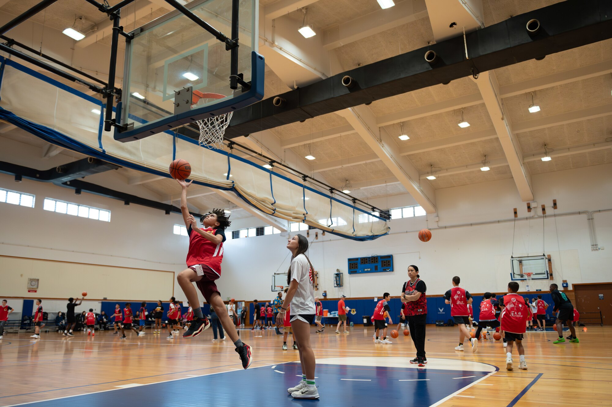 Child attempt a lay up during a basketball camp