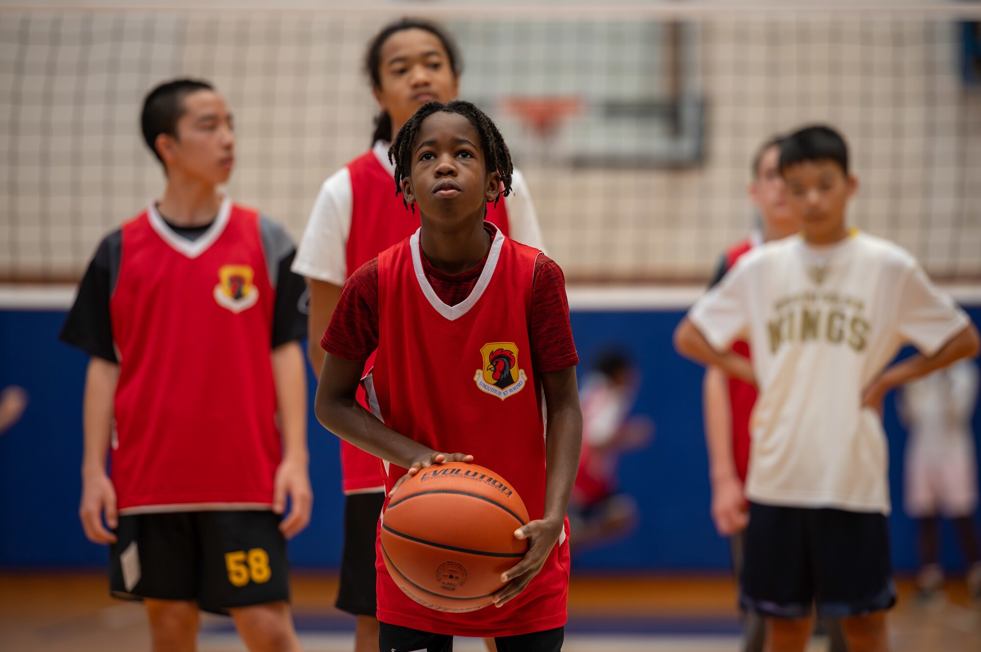 Child prepares to shoot a basketball