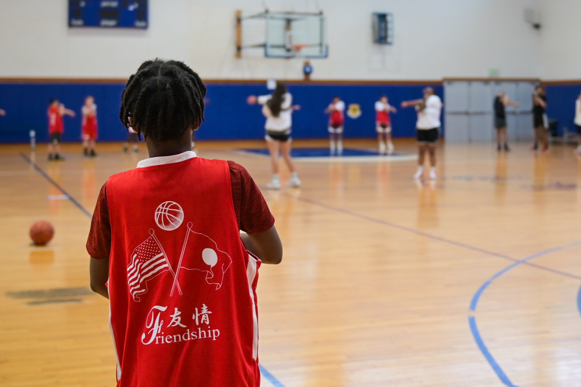 Child wears a basketball jersey