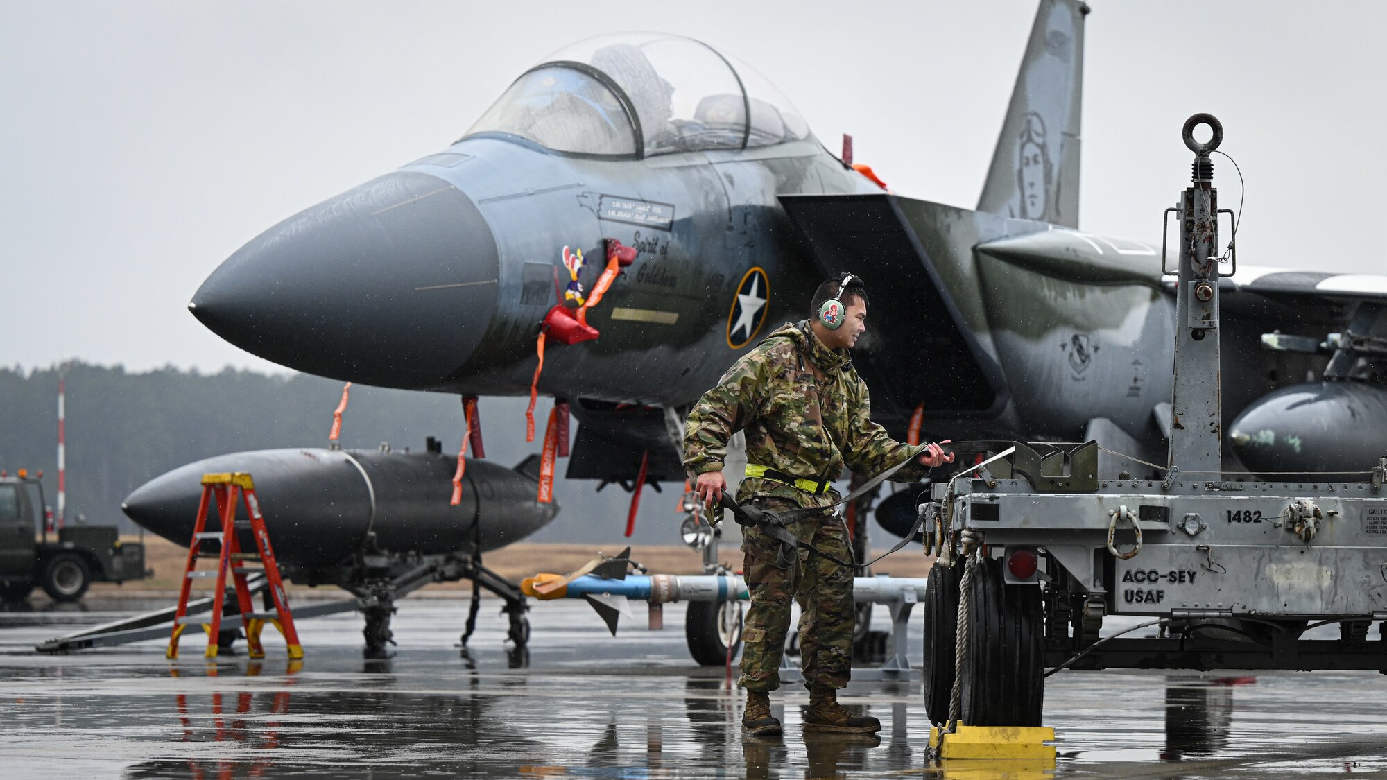 U.S. Air Force Staff Sgt. Jeffrey Pagtama, a weapons load crew chief assigned to the 333rd Fighter Generation Squadron, prepare to load munitions during an annual load crew competition at Seymour Johnson Air Force Base, North Carolina, on February 23, 2024. Every year, a load crew from each unit goes head-to-head in a competition that tests their dress and appearance, weapons knowledge and speed and accuracy of loading munitions on an F-15E Strike Eagle. (U.S. Air Force photo by Staff Sgt. Koby I. Saunders)