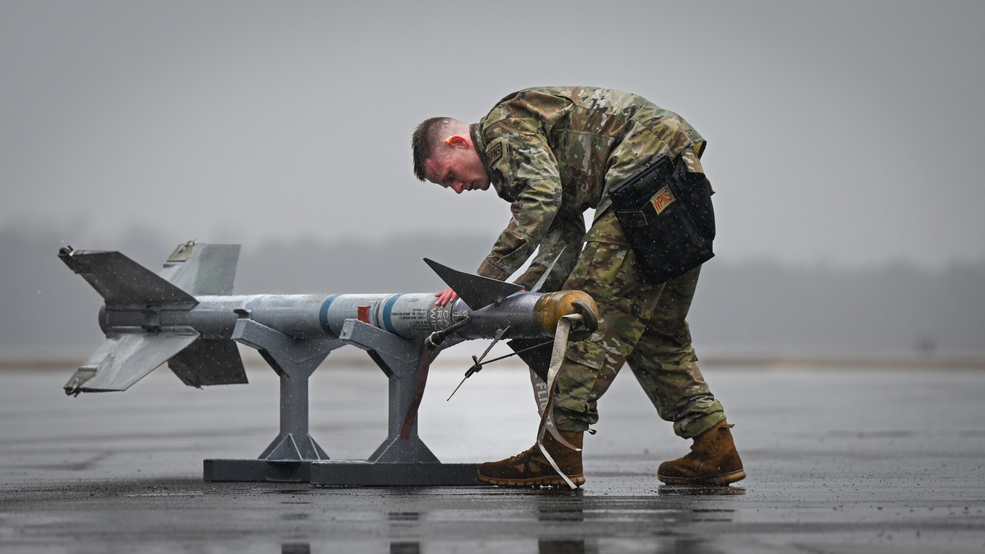 U.S. Air Force William Bryce, a weapons load crew member assigned to the 414th Fighter Group, participates in an annual load crew competition at Seymour Johnson Air Force Base, North Carolina, on February 23, 2024. Every year, a load crew from each unit goes head-to-head in a competition that tests their dress and appearance, weapons knowledge and speed and accuracy of loading munitions on an F-15E Strike Eagle. (U.S. Air Force photo by Staff Sgt. Koby I. Saunders)