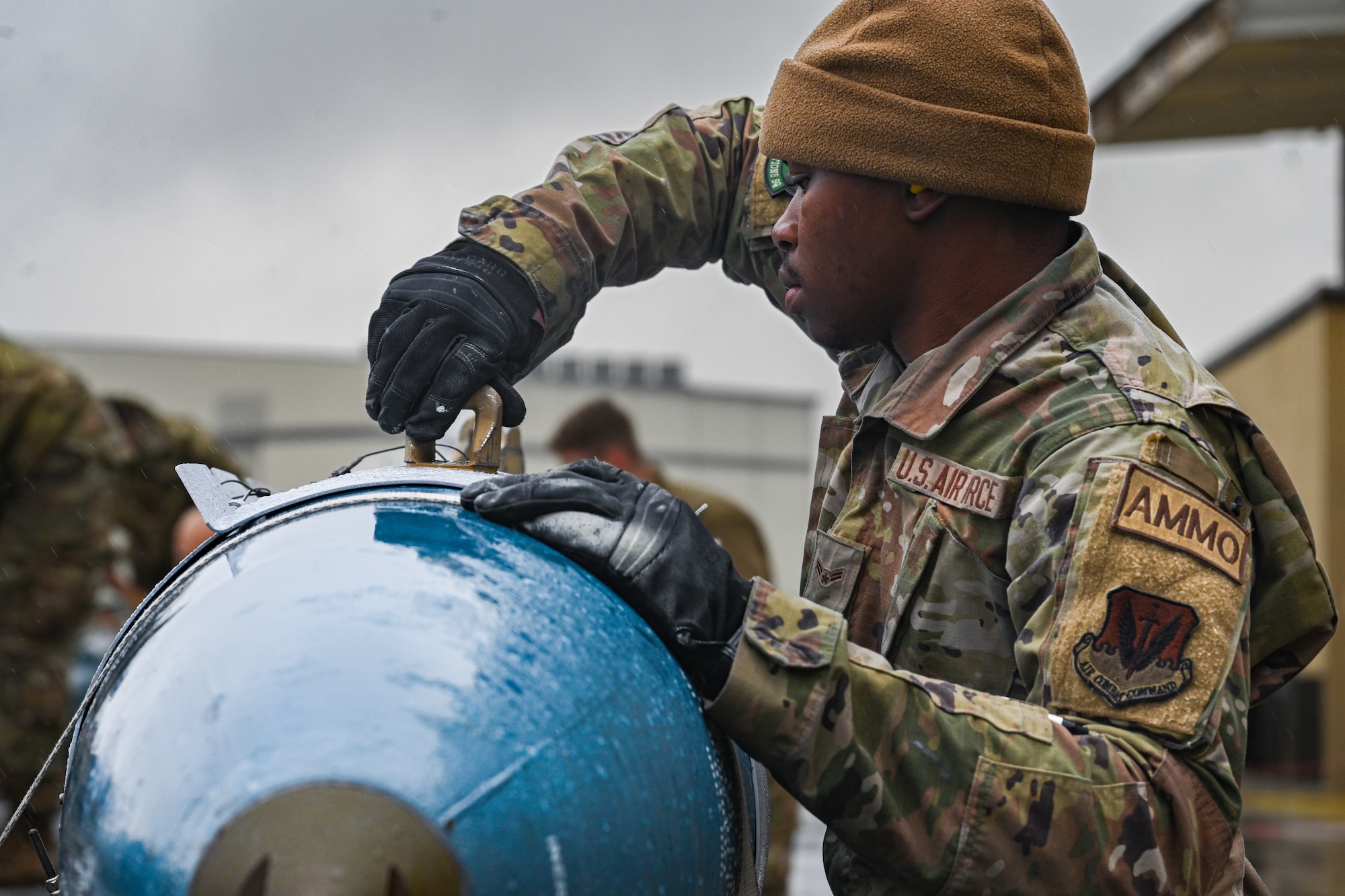 U.S. Air Force Airman 1st Class Jakob Moore, a conventional maintenance crew chief assigned to the 4th Munitions Squadron,  prepares munitions during an annual load crew competition at Seymour Johnson Air Force Base, North Carolina, on February 23, 2024. Every year, a load crew from each unit goes head-to-head in a competition that tests their dress and appearance, weapons knowledge and speed and accuracy of loading munitions on an F-15E Strike Eagle. (U.S. Air Force photo by Staff Sgt. Koby I. Saunders)