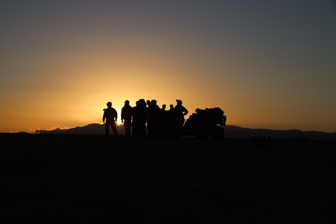 U.S. Marines with 1st Marine Reconnaissance Battalion, 1st Marine Division, await transport with an ultra-light tactical vehicle, during Marine Air-Ground Task Force Distributed Exercise (MDMX) at the Marine Corps Air-Ground Combat Center, Twentynine Palms, California, Feb. 10, 2024. The Marines with 1st Recon began MDMX by conducting a tactical night insertion into an austere environment. MDMX is a maneuver exercise that incorporates ground, air, and logistics operations over several days. (U.S. Marine Corps photo by Sgt. Sean Potter)