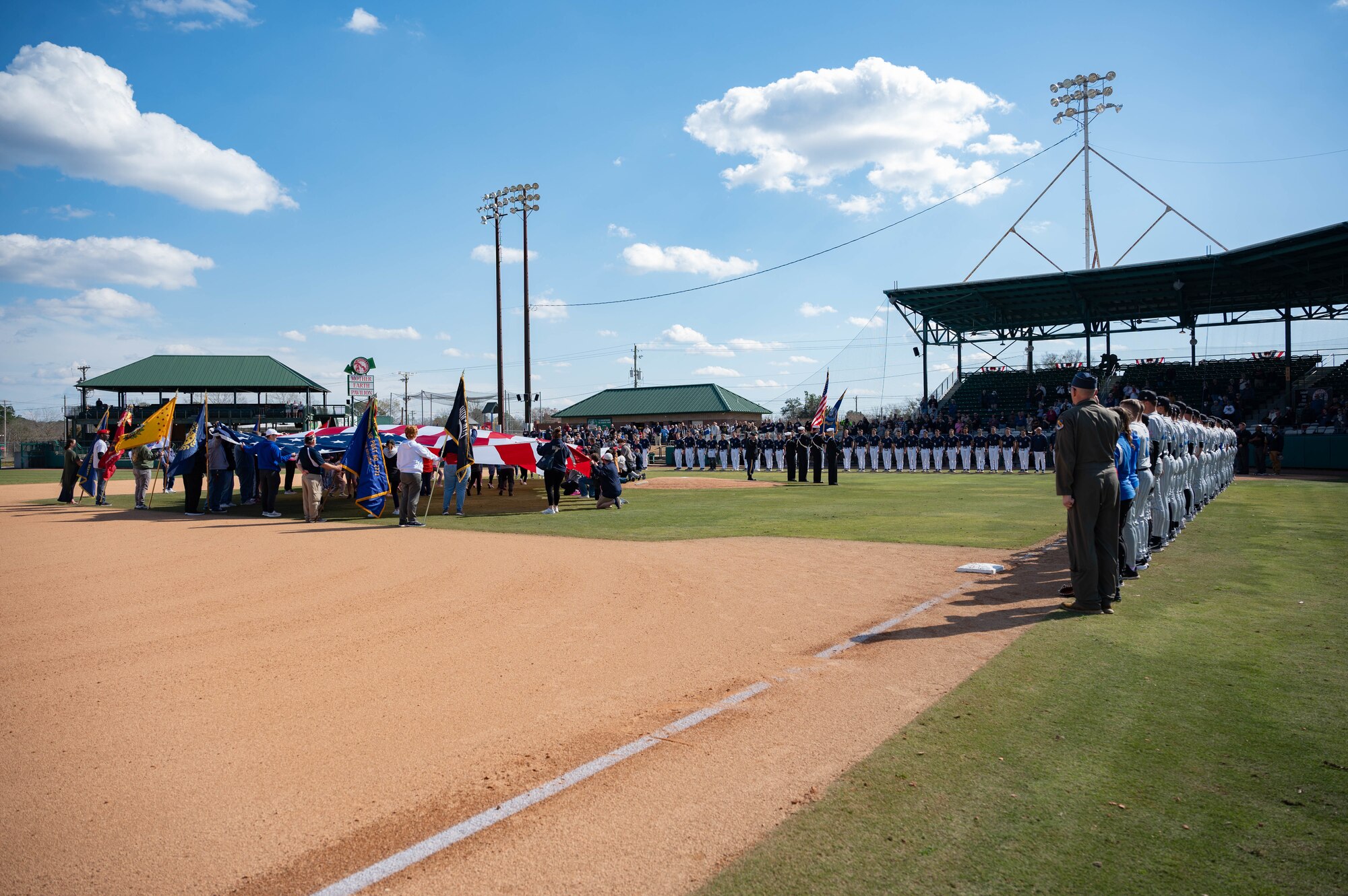 Airmen from Seymour Johnson Air Force Base hold the American Flag during the 14th Annual Freedom Classic baseball series at Grainger Stadium in Kinston, North Carolina, Feb. 24, 2024. Airmen held the flag during the singing of the National Anthem. (U.S. Air Force photo by Airman 1st Class Rebecca Sirimarco-Lang)