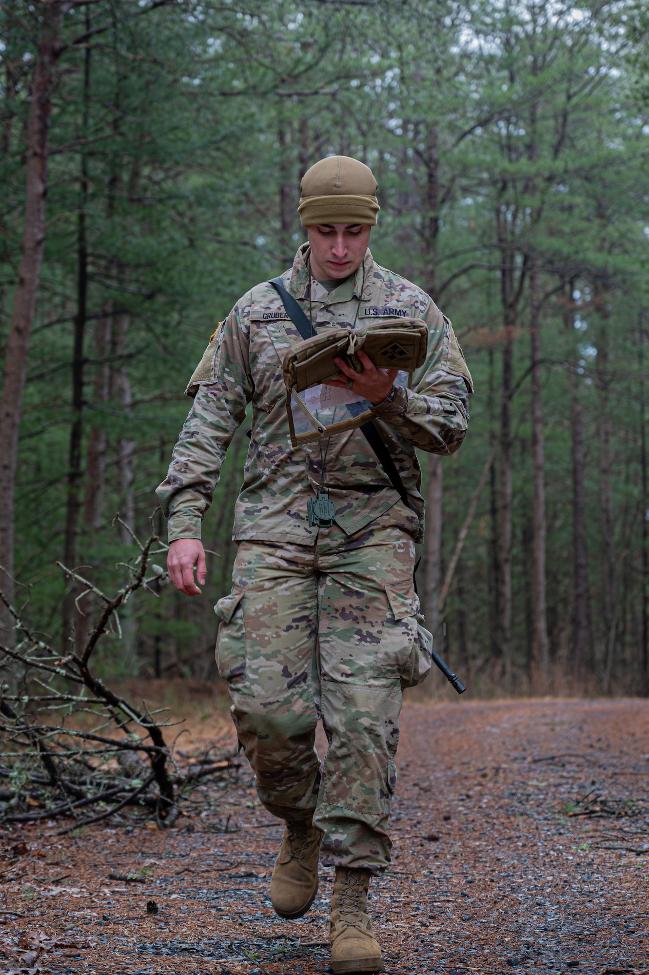 U.S. Army Spc. Trevor Gruber, Alpha Company, 378th Expeditionary Military Intelligence Battalion, 336th Expeditionary Military Intelligence Brigade, Military Intelligence Readiness Command intelligence analyst, participates in a land navigation event during the Best Warrior Competition at Joint Base McGuire-Dix-Lakehurst, N.J., Feb. 22, 2024. Participants underwent rigorous evaluations by seasoned leaders who are subject matter experts in their respective fields. The assessments encompassed a wide range of military skills tests, including physical fitness, weapons knowledge, marksmanship, land navigation, general military knowledge and more. (U.S. Air Force photo by Senior Airman Simonne Barker)