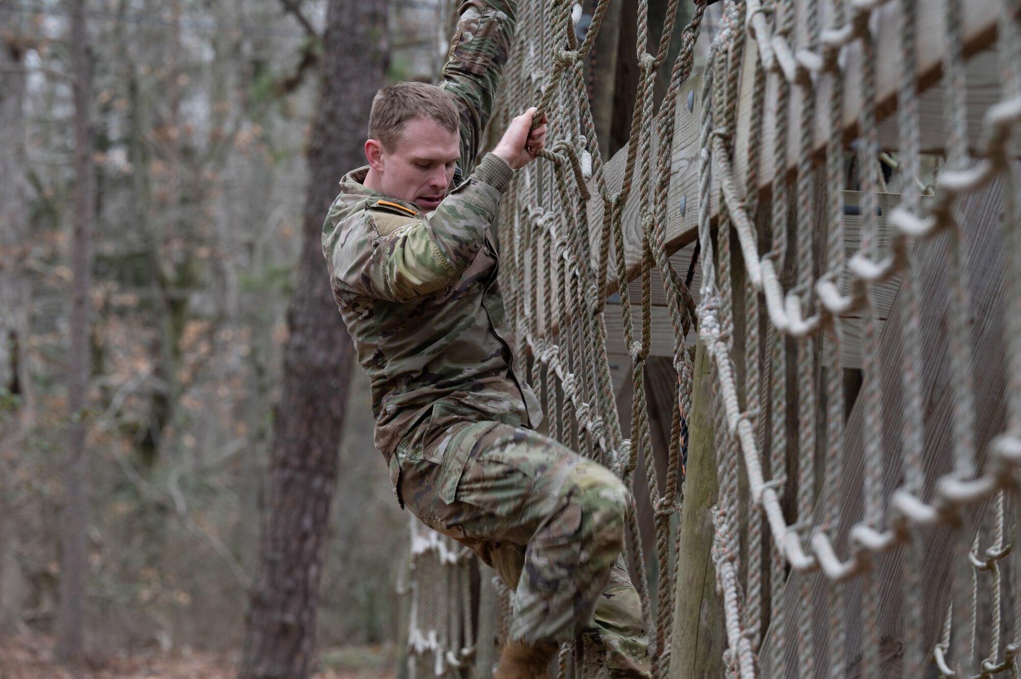 U.S. Army Staff Sgt. Timothy Sullivan, Detachment 3, 2300 Military Intelligence Group, National Intelligence Support Group, Military Intelligence Readiness Command intelligence analyst, competes on an obstacle course during the Best Warrior Competition at Joint Base McGuire-Dix-Lakehurst, N.J., Feb. 22, 2024. Participants underwent rigorous evaluations by seasoned leaders who are subject matter experts in their respective fields. The assessments encompassed a wide range of military skills tests, including physical fitness, weapons knowledge, marksmanship, land navigation, general military knowledge and more. (U.S. Air Force photo by Airman 1st Class Aidan Thompson)