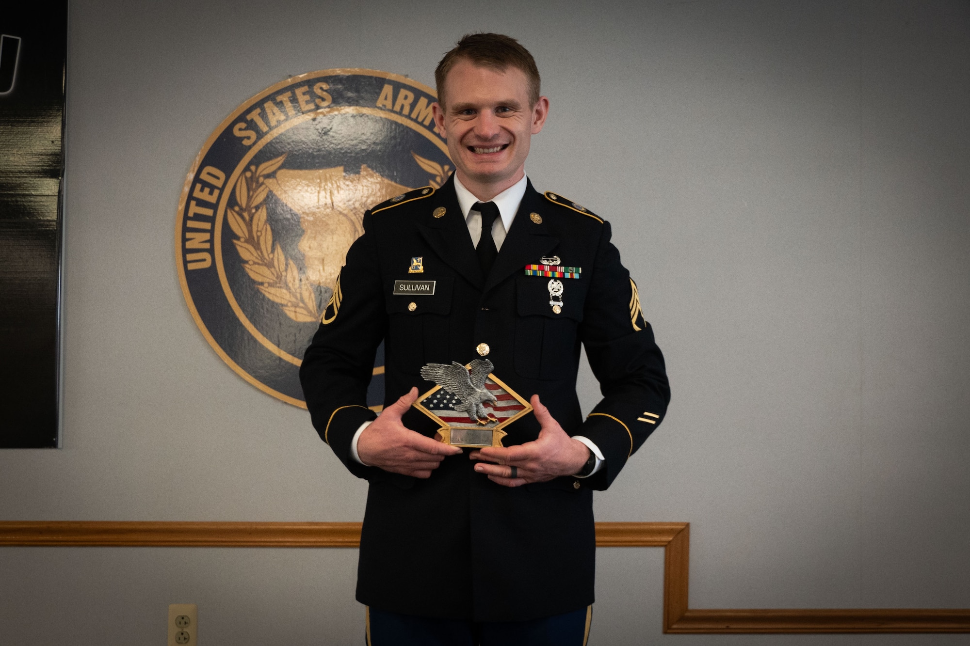 U.S. Army Staff Sgt. Timothy Sullivan, Detachment 3, 2300 Military Intelligence Group, National Intelligence Support Group, Military Intelligence Readiness Command intelligence analyst, holds his award for the 336th Expeditionary Military Intelligence Brigade’s 2024 Best Warrior NCO during the Best Warrior Competition awards ceremony at Joint Base McGuire-Dix-Lakehurst, N.J., Feb. 22, 2024. Participants underwent rigorous evaluations by seasoned leaders who are subject matter experts in their respective fields. The assessments encompassed a wide range of military skills tests, including physical fitness, weapons knowledge, marksmanship, land navigation, general military knowledge and more. (U.S. Air Force photo by 2nd Lt. Alexis Kula)