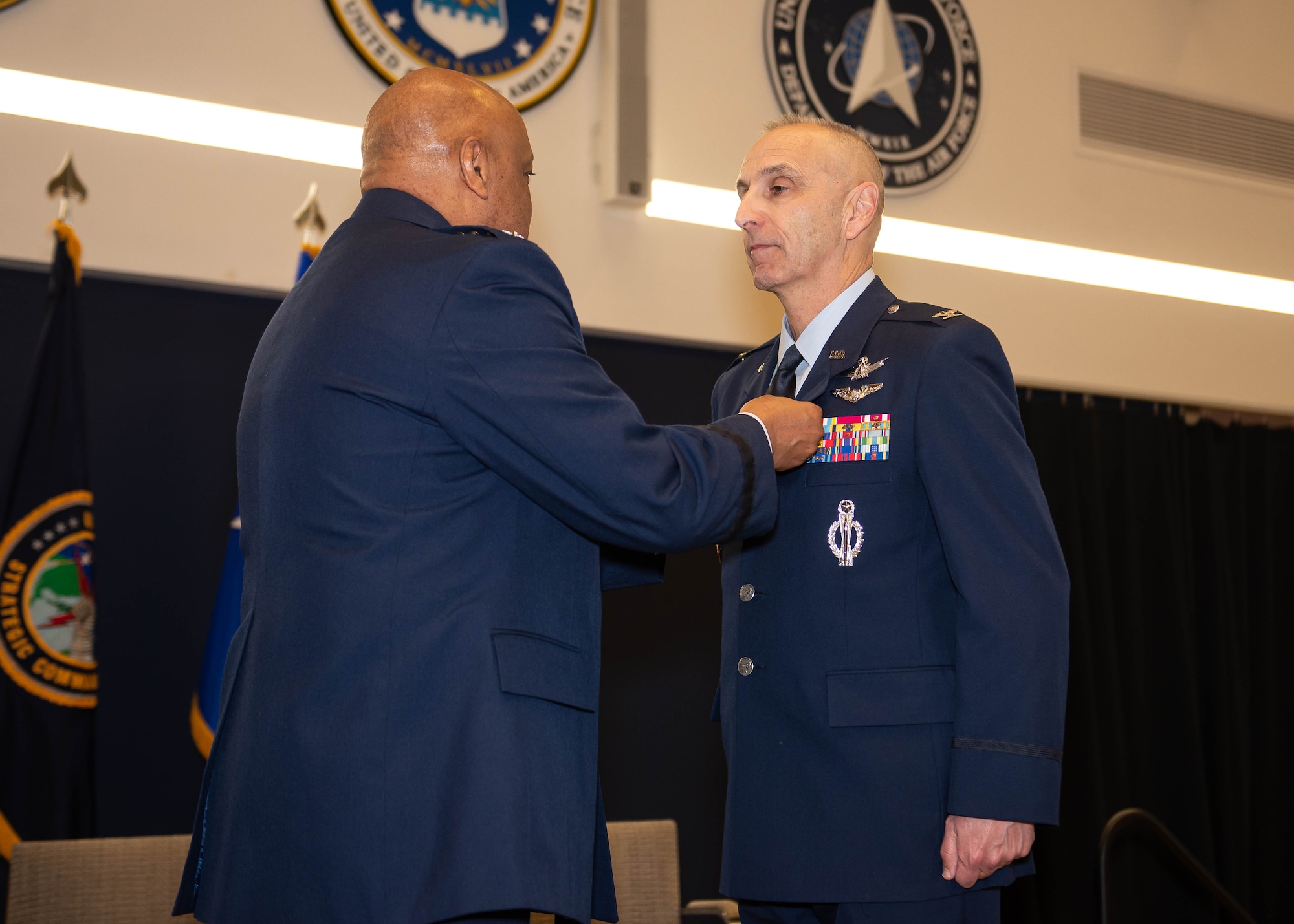 General cotton pins a medal on colonel buzzell