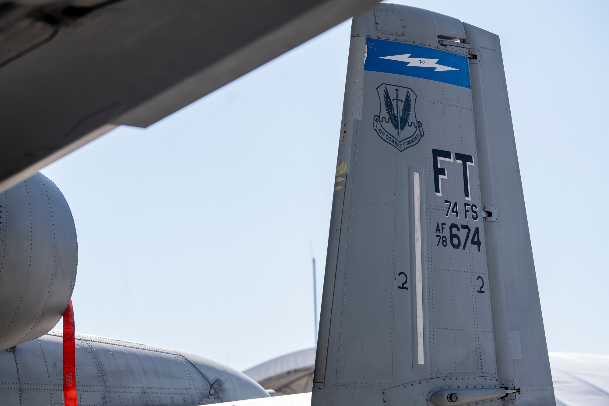 Aircraft 78-0674, a U.S. Air Force A-10C Thunderbolt II flagship assigned to the 74th Fighter Squadron, rests under a sunshade